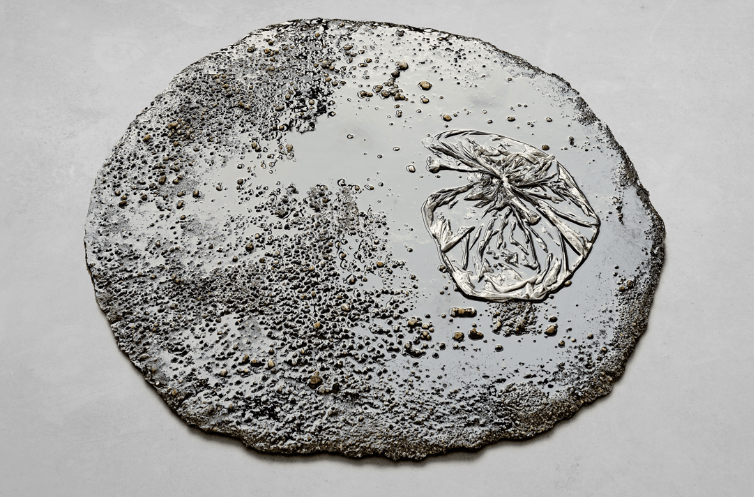 Marlie Mul, Puddle (Black Market), 2013, Sand, stones, resin, plastic bag, 2 x 80 cm. Courtesy: the artist and Croy Nielsen, Berlin